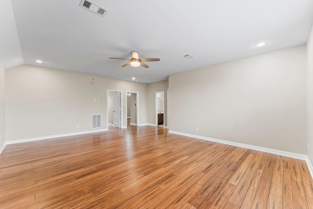 spare room with baseboards, visible vents, a ceiling fan, and light wood finished floors