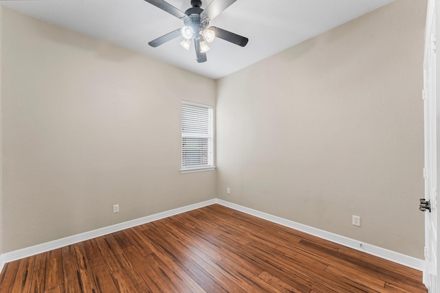 empty room featuring dark wood-style floors, ceiling fan, and baseboards