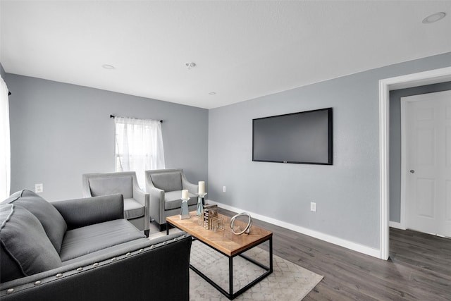 living area with dark wood-style floors and baseboards