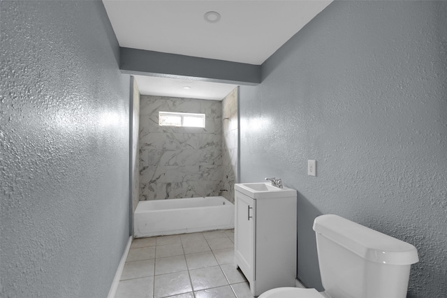 bathroom with toilet, tile patterned floors, vanity, and a textured wall