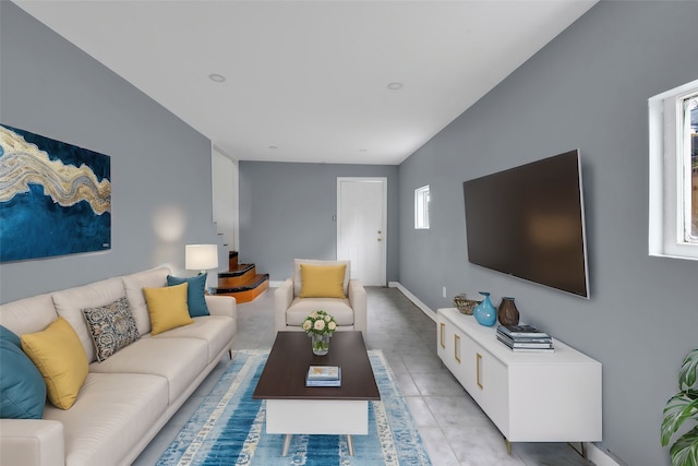 living room with light tile patterned flooring and baseboards