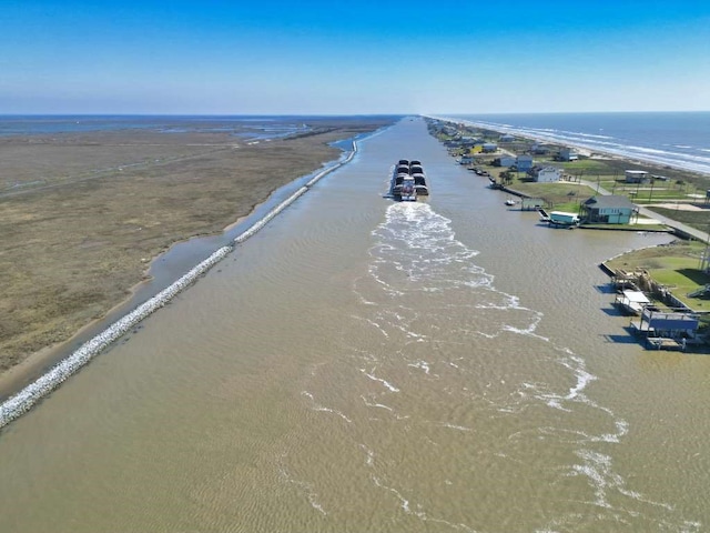 birds eye view of property featuring a water view and a beach view