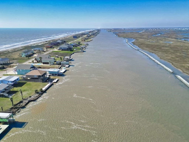 birds eye view of property with a water view and a view of the beach