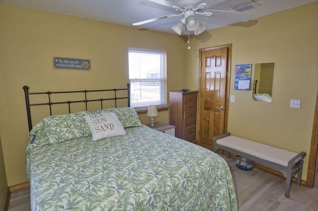 bedroom featuring visible vents and wood finished floors