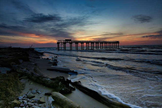 view of dock featuring a pier and a water view