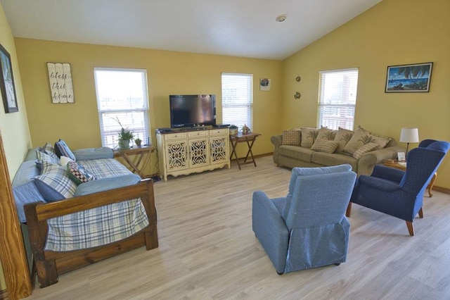 living area with lofted ceiling and light wood-style flooring