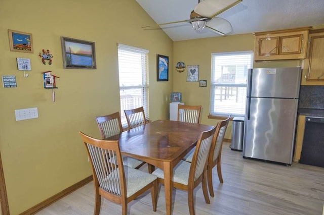 dining area with lofted ceiling, ceiling fan, plenty of natural light, and light wood-style floors