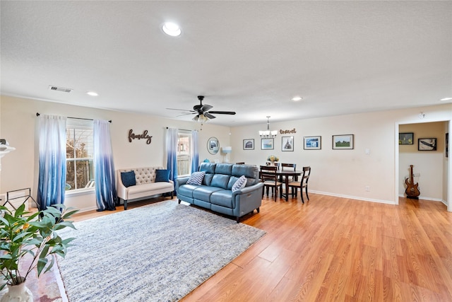 1009 Canadian St, Houston, TX 77009 - living area with visible vents, baseboards, recessed lighting, light wood-style floors, and ceiling fan with notable chandelier