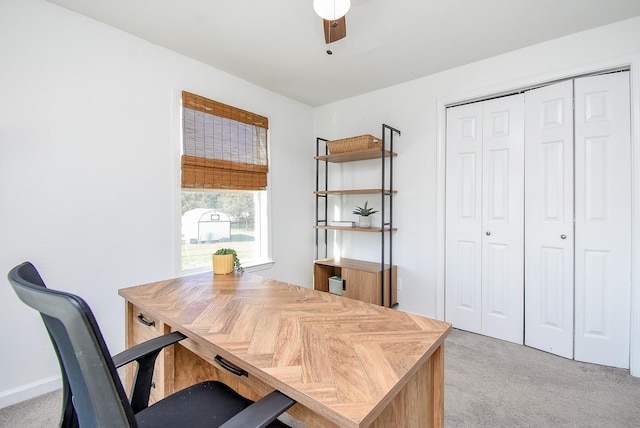 home office with light carpet and ceiling fan