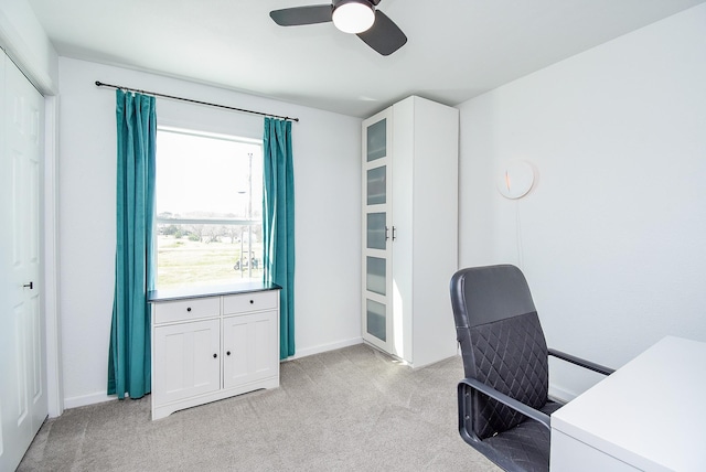 office space featuring light carpet and ceiling fan