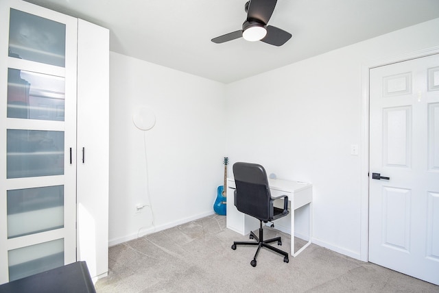 office with a ceiling fan, light colored carpet, and baseboards