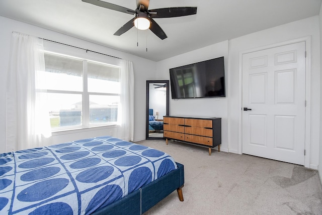 carpeted bedroom featuring a ceiling fan and baseboards