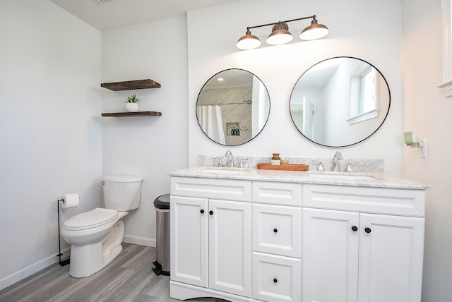 full bath featuring wood finished floors, curtained shower, a sink, and toilet