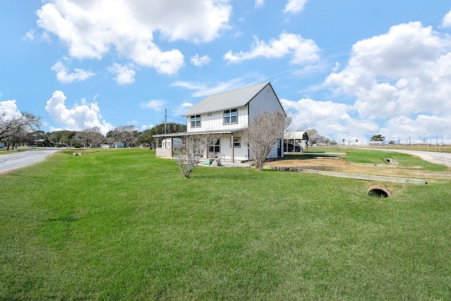 view of front of house with a front yard and metal roof