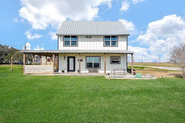 back of property featuring metal roof, board and batten siding, and a yard