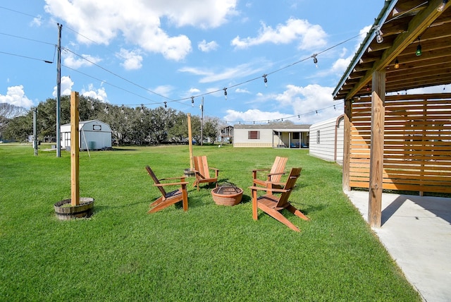 view of yard with a storage shed, an outdoor fire pit, and an outdoor structure