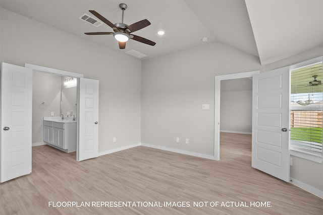 unfurnished bedroom with vaulted ceiling, light wood-style flooring, visible vents, and baseboards