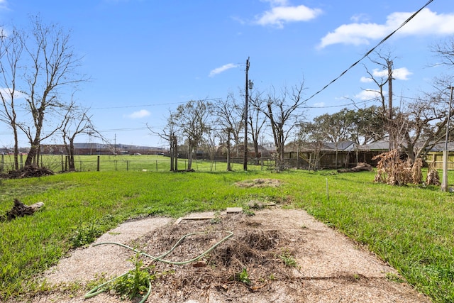 view of yard featuring a rural view and fence