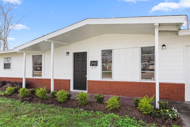 property entrance with brick siding