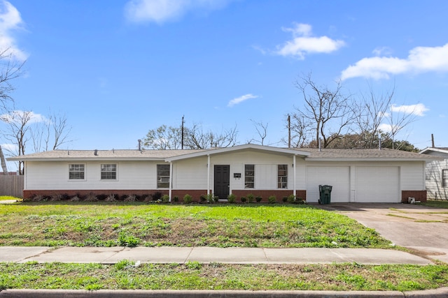 view of front of home with concrete driveway, brick siding, an attached garage, and a front yard