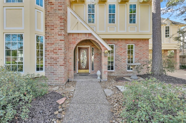 entrance to property with brick siding and stucco siding