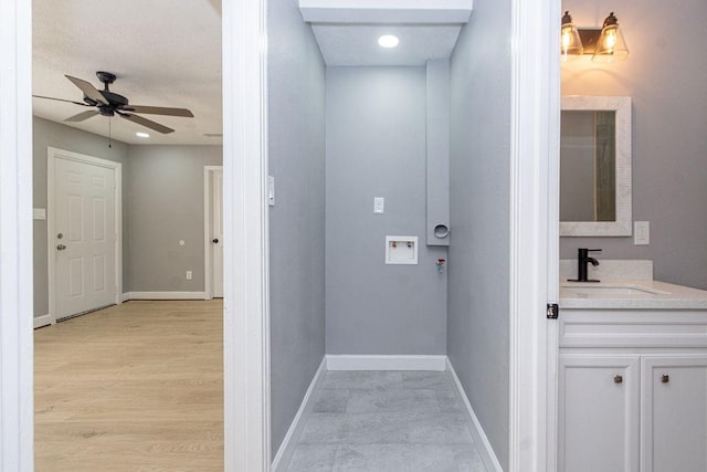 interior space with baseboards and a sink