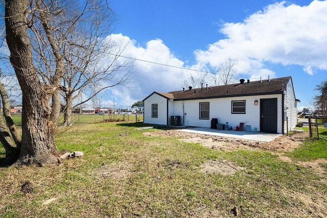 back of house with cooling unit, a patio area, fence, and a lawn