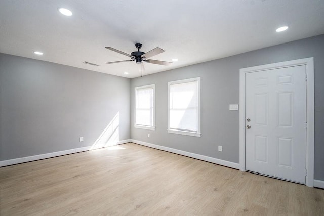 unfurnished room featuring light wood-style floors, baseboards, visible vents, and recessed lighting