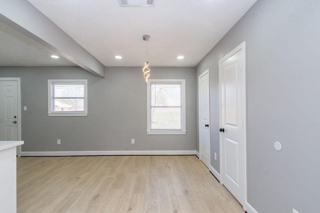 unfurnished dining area with light wood-style floors, plenty of natural light, baseboards, and recessed lighting