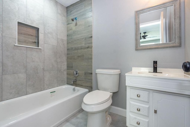 bathroom featuring shower / tub combination, toilet, vanity, baseboards, and tile patterned floors