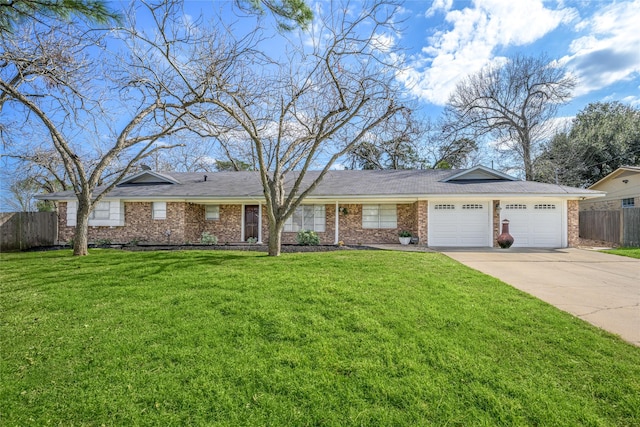 ranch-style house featuring a front yard, concrete driveway, fence, and an attached garage