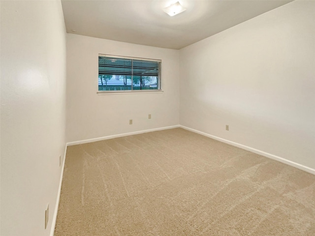 empty room with carpet and baseboards