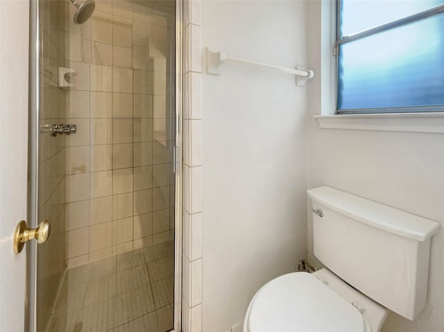 full bath featuring a stall shower and toilet