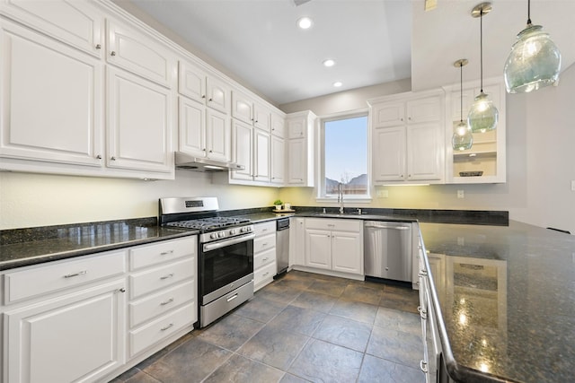 kitchen featuring under cabinet range hood, appliances with stainless steel finishes, a sink, and white cabinetry