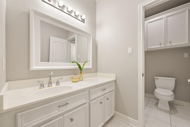 bathroom with tile patterned floors, baseboards, toilet, and vanity
