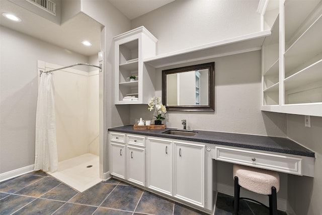 interior space with vanity, visible vents, baseboards, recessed lighting, and a stall shower