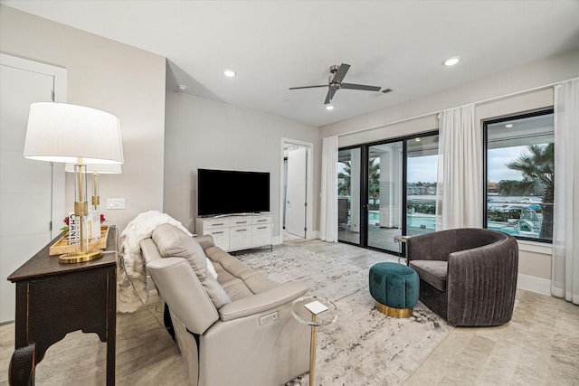 living area featuring ceiling fan, baseboards, and recessed lighting