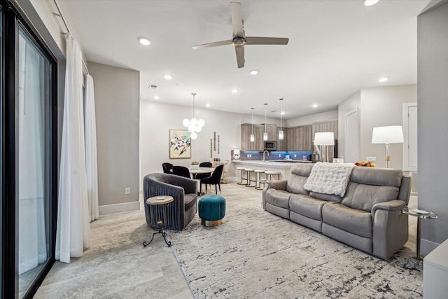 living room featuring recessed lighting, ceiling fan, and baseboards