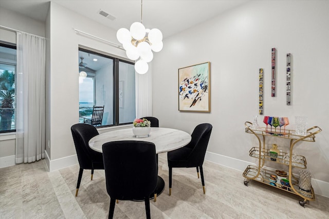 dining area featuring baseboards, visible vents, and a notable chandelier