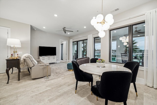 dining room featuring a healthy amount of sunlight, visible vents, a notable chandelier, and recessed lighting