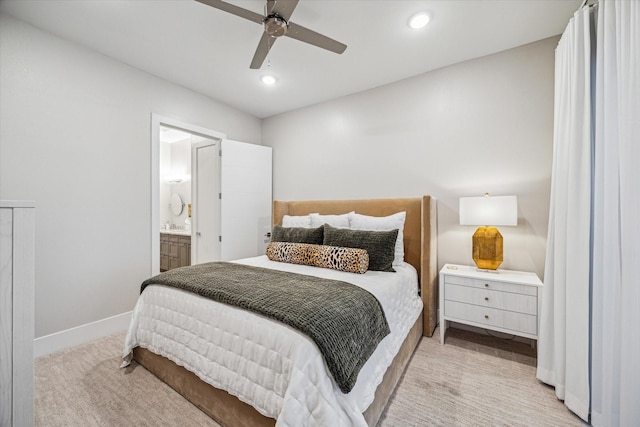 bedroom featuring ceiling fan, recessed lighting, light colored carpet, baseboards, and ensuite bath