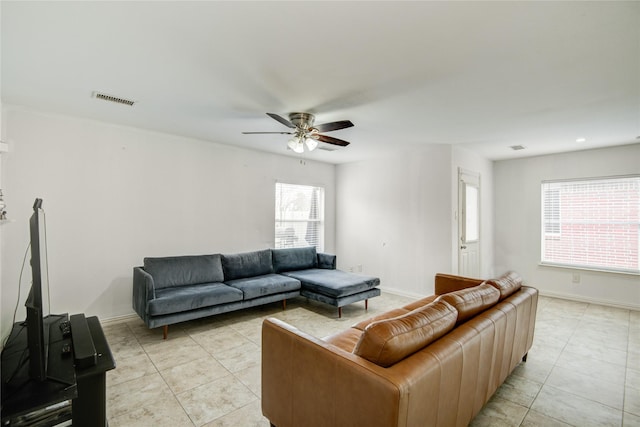 living area with visible vents, baseboards, and light tile patterned floors