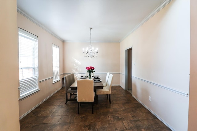 dining space featuring ornamental molding, a chandelier, and baseboards