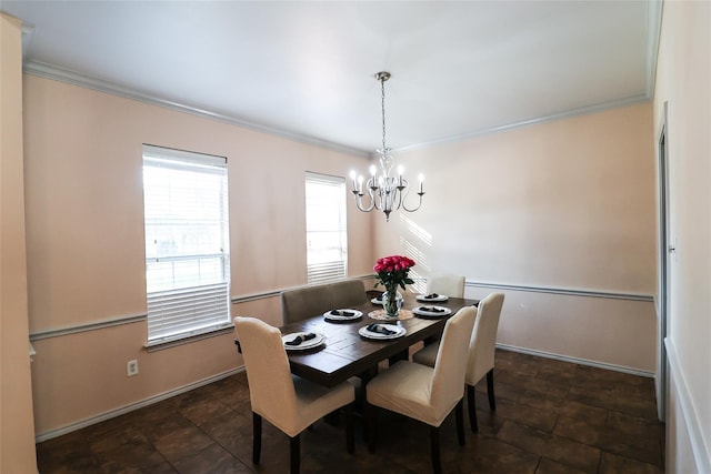 dining area featuring baseboards, a chandelier, and crown molding