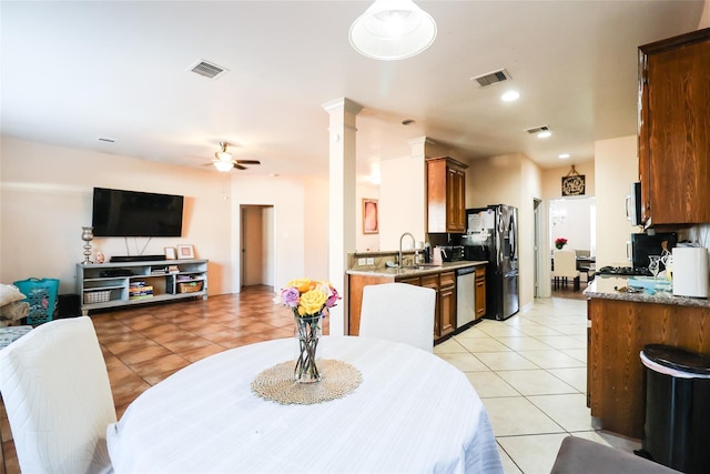 dining area with visible vents, ceiling fan, decorative columns, and light tile patterned floors