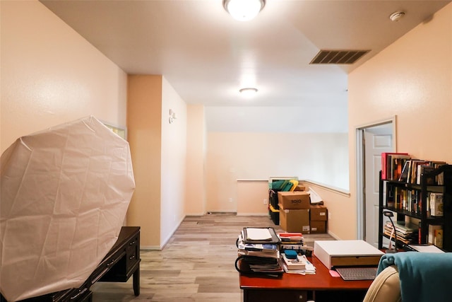 office featuring light wood-style flooring, visible vents, and baseboards