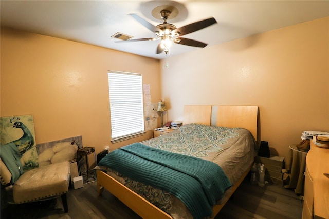 bedroom with ceiling fan, visible vents, and dark wood-style flooring