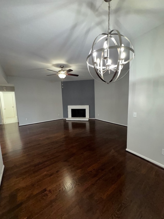 9809 Richmond Ave Unit J1, Houston, TX 77042 - unfurnished living room with ceiling fan, a chandelier, a fireplace with raised hearth, and wood finished floors