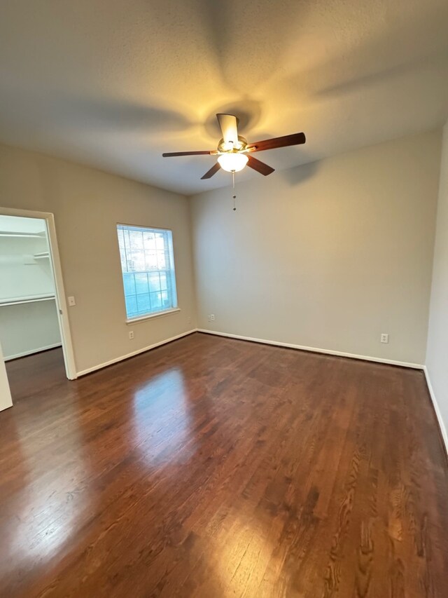 9809 Richmond Ave Unit J1, Houston, TX 77042 - empty room featuring dark wood-style floors and a ceiling fan