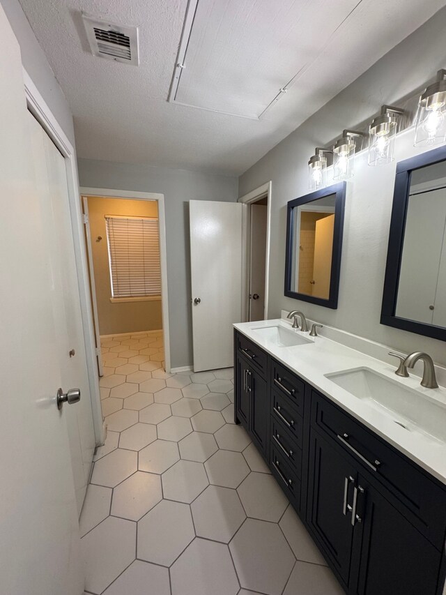 9809 Richmond Ave Unit J1, Houston, TX 77042 - bathroom featuring double vanity and tile patterned floors